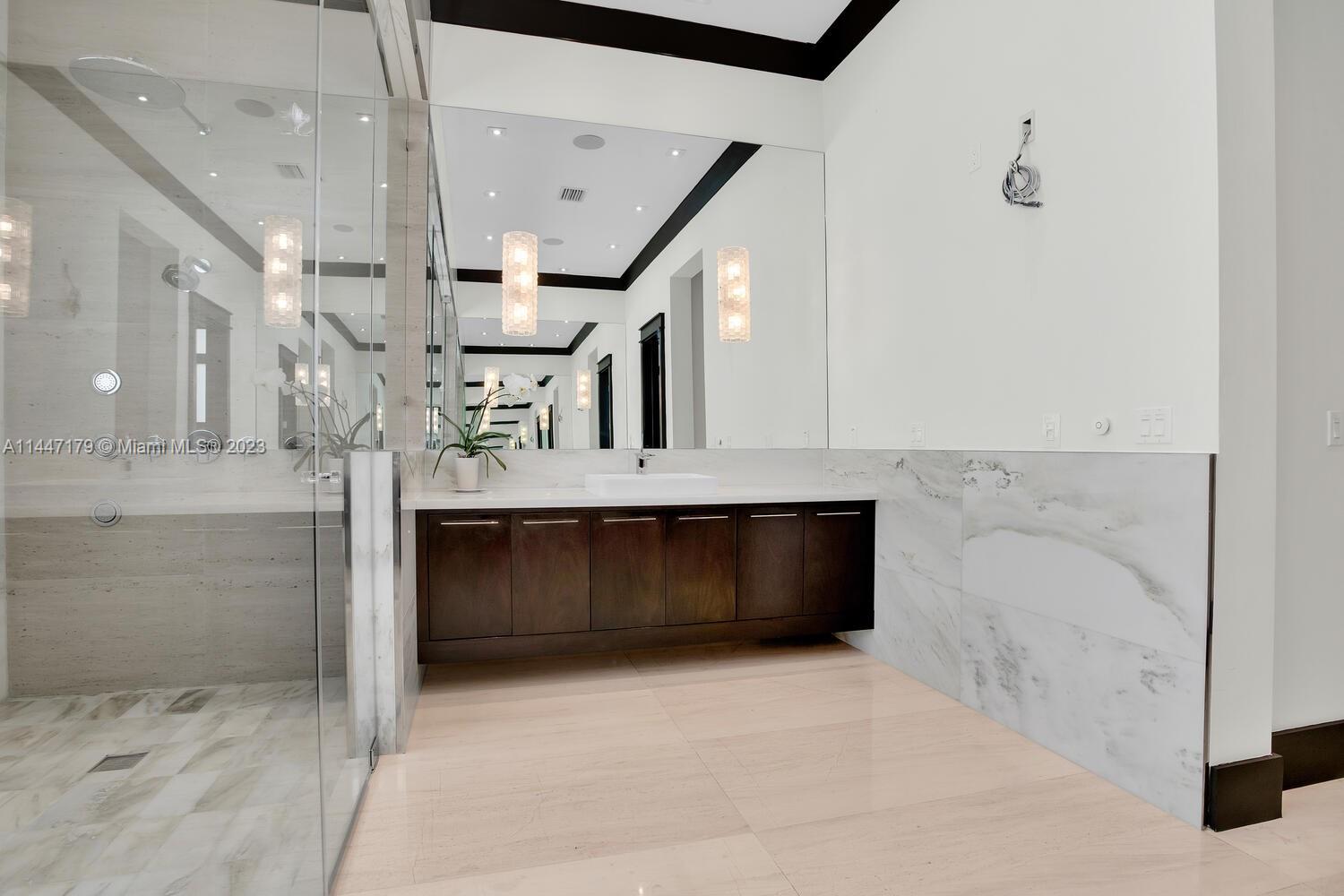 11880 Southwest 47th Street Miami, FL 33175 - Photo 29 of 61 a bathroom with a sink and a mirror