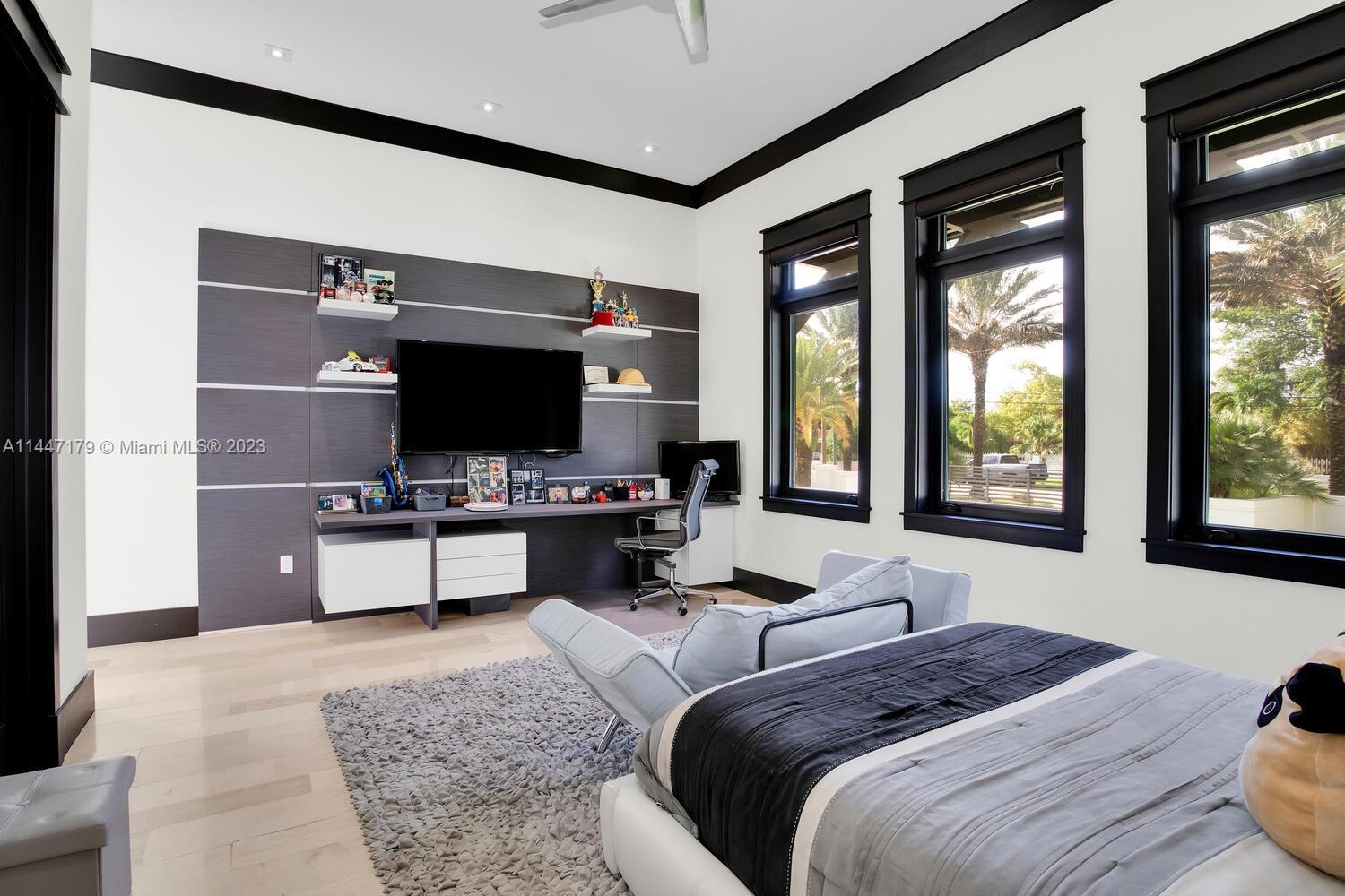 11880 Southwest 47th Street Miami, FL 33175 - Photo 32 of 61 a bedroom with a bed and a flat tv screen on dresser