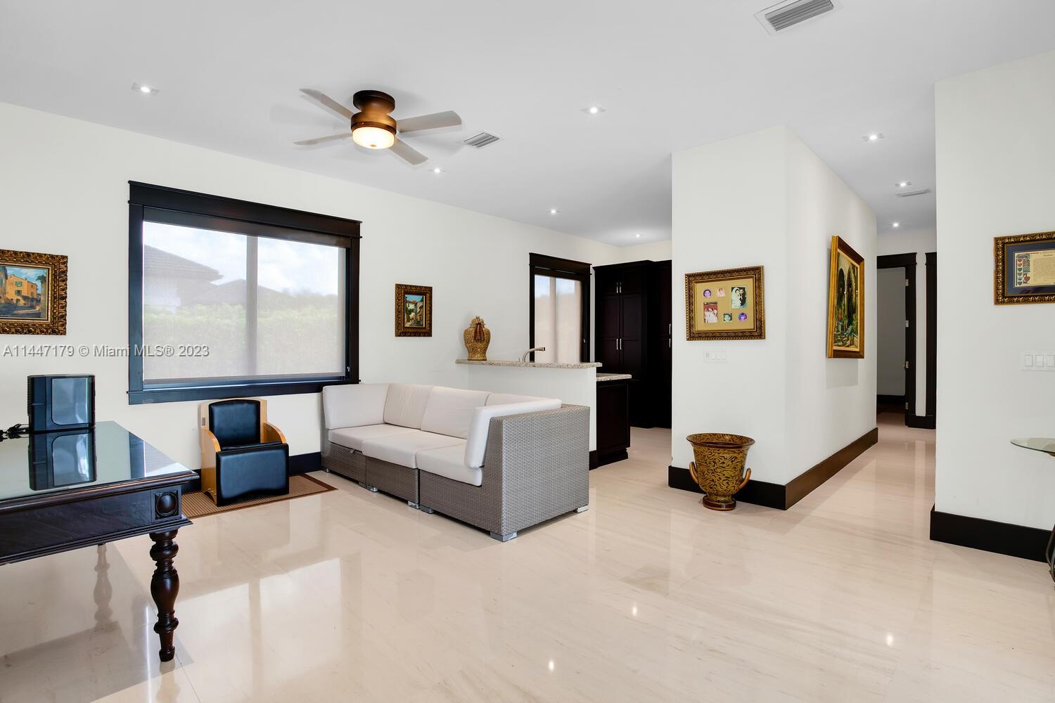 11880 Southwest 47th Street Miami, FL 33175 - Photo 37 of 61 a living room with furniture gym equipment and a large window