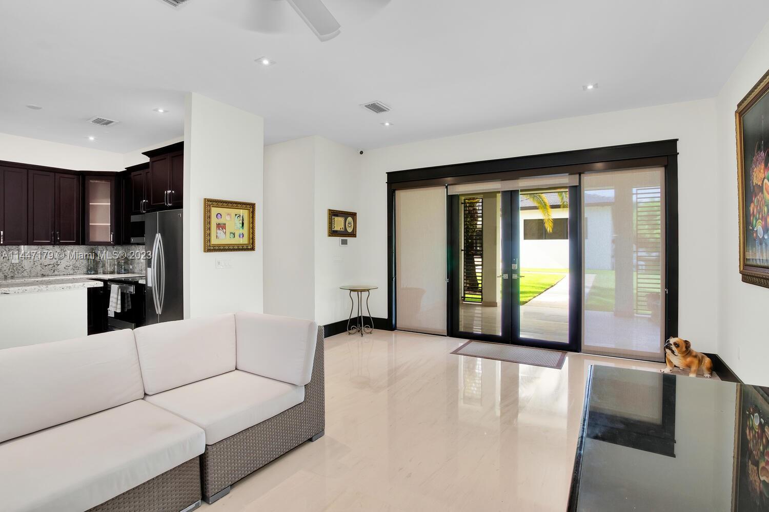 11880 Southwest 47th Street Miami, FL 33175 - Photo 38 of 61 a living room with furniture and a large window