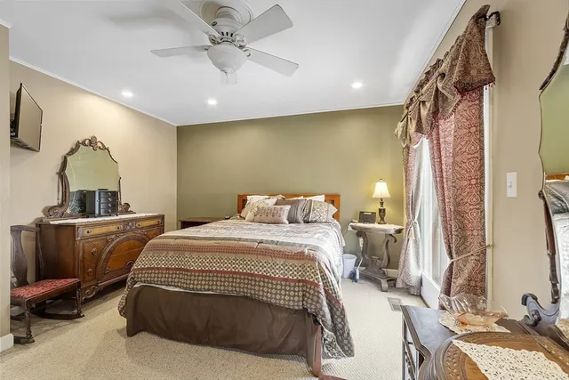 a bedroom with a bed and a mirror