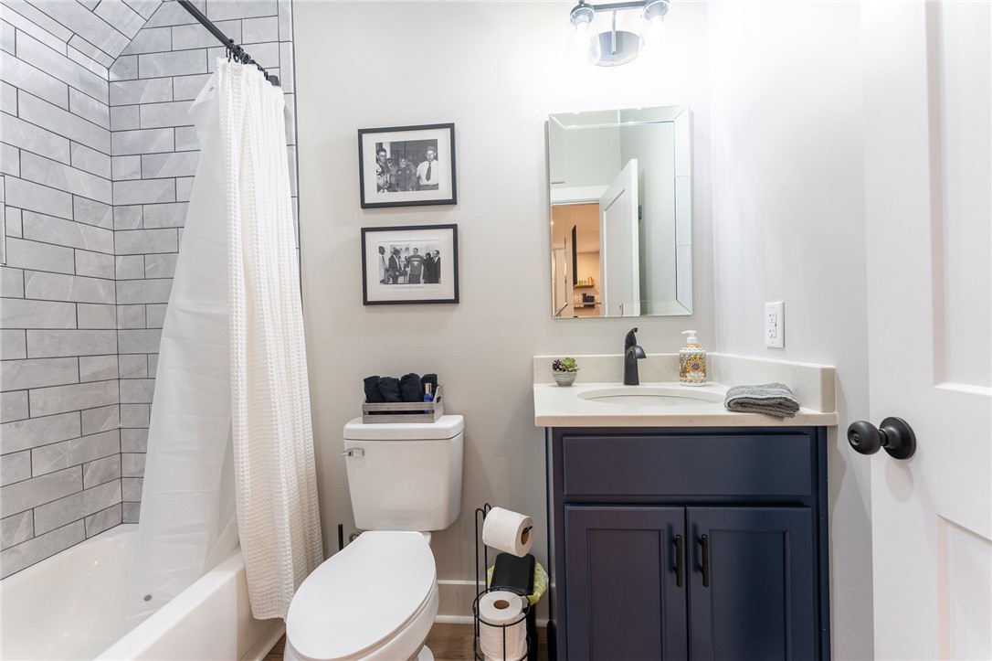 103 Riggs Drive Clemson, SC 29631 - Photo 44 of 50 A well-appointed bathroom with a white subway-tiled shower and dark-wood vanity provides comfort and style.