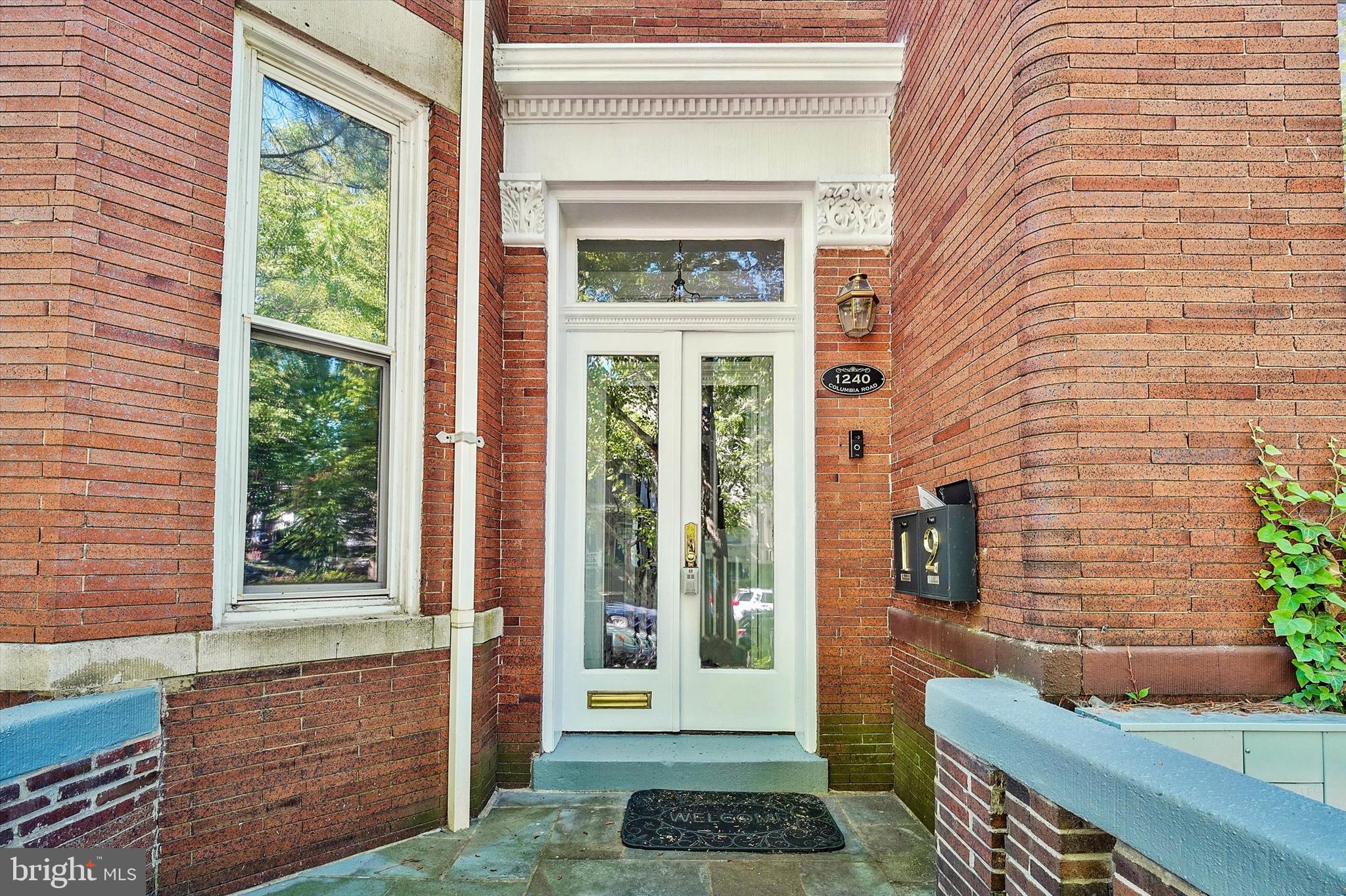 1240 Columbia Road Northwest, Unit 1 Washington, DC 20009 - Photo 19 of 25 a view of a brick house with a large window