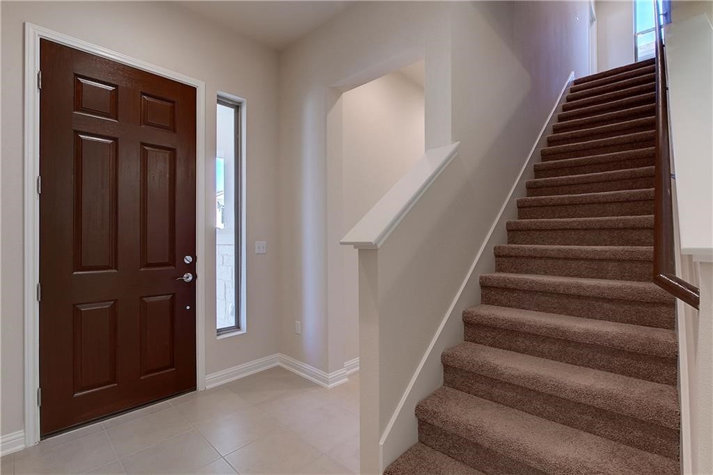 6907 Idea Road Austin, TX 78741 - Photo 3 of 29 Entryway with main level bedroom to the left and stairs to the other bedrooms.