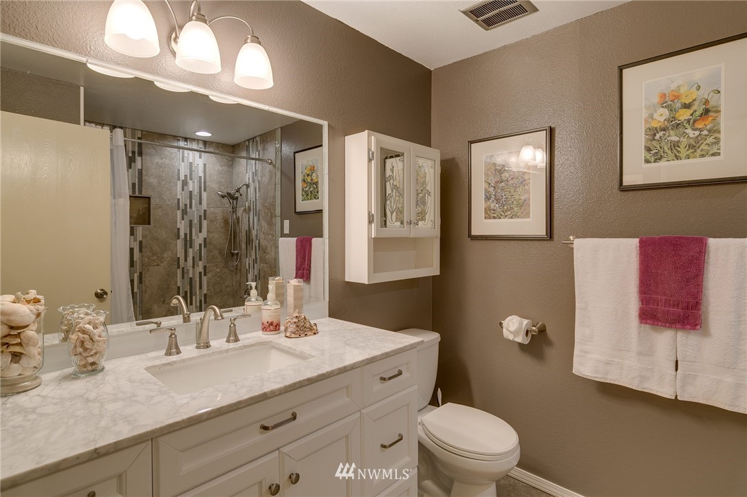519 213th Place Southwest Bothell, WA 98021 - Photo 19 of 34 a bathroom with a granite countertop sink mirror vanity and toilet