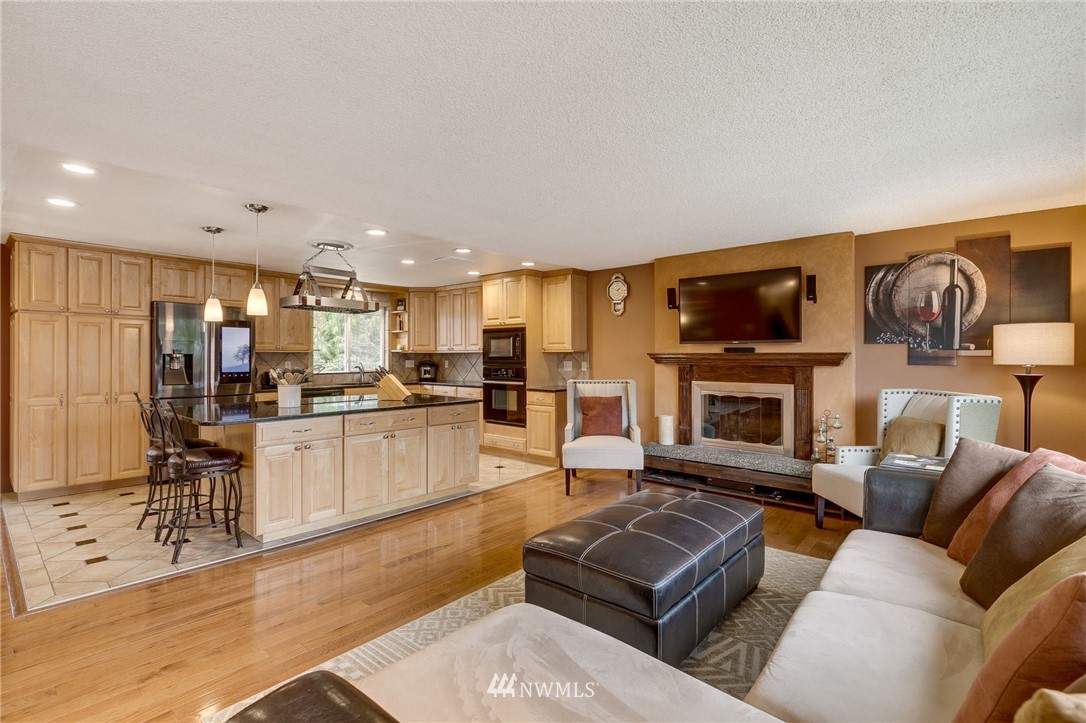 519 213th Place Southwest Bothell, WA 98021 - Photo 2 of 34 a living room with furniture a fireplace and a flat screen tv