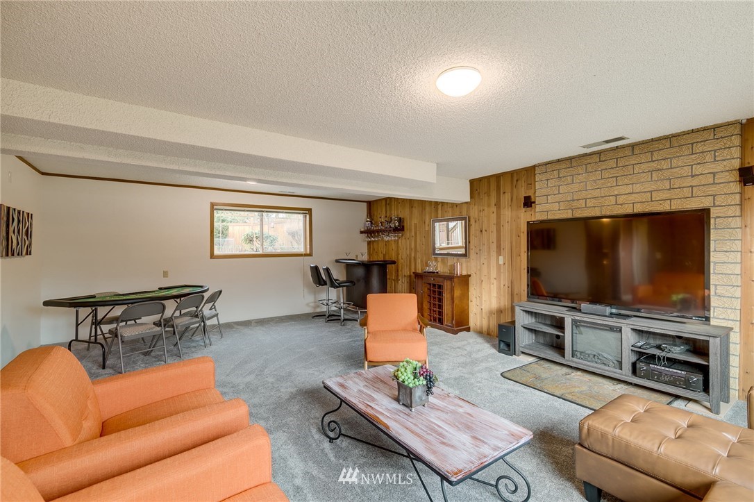 519 213th Place Southwest Bothell, WA 98021 - Photo 22 of 34 a living room with furniture and a flat screen tv