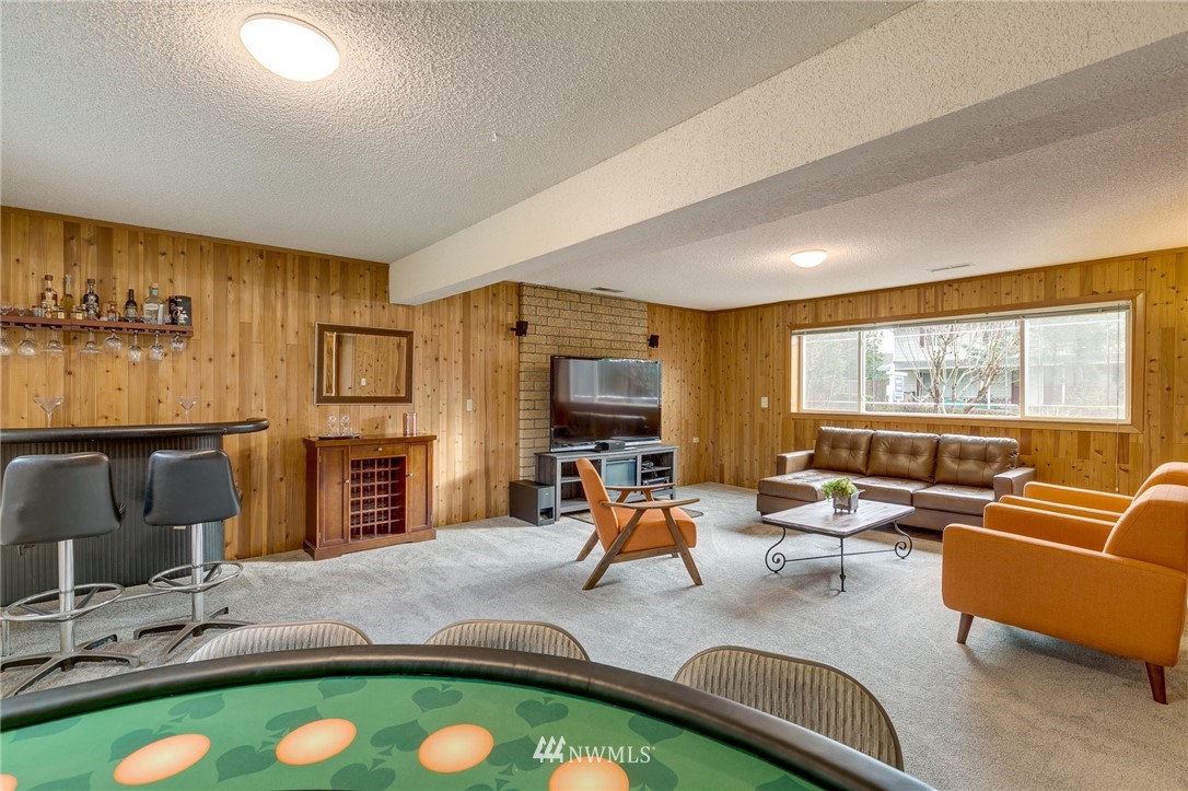 519 213th Place Southwest Bothell, WA 98021 - Photo 23 of 34 a living room with furniture a flat screen tv and a large window
