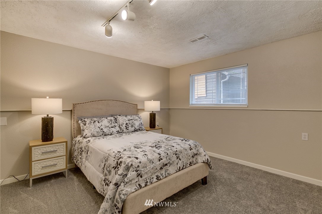 519 213th Place Southwest Bothell, WA 98021 - Photo 24 of 34 a bedroom with a bed and a night stand