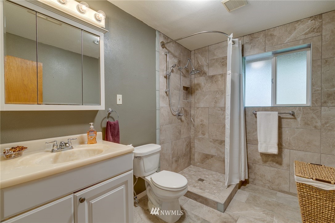 519 213th Place Southwest Bothell, WA 98021 - Photo 25 of 34 a bathroom with a sink toilet and shower