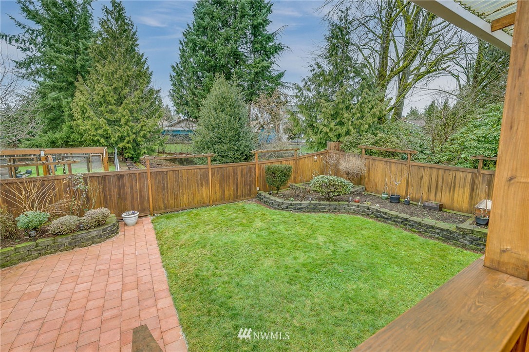 519 213th Place Southwest Bothell, WA 98021 - Photo 34 of 34 a view of a backyard with plants and a bench