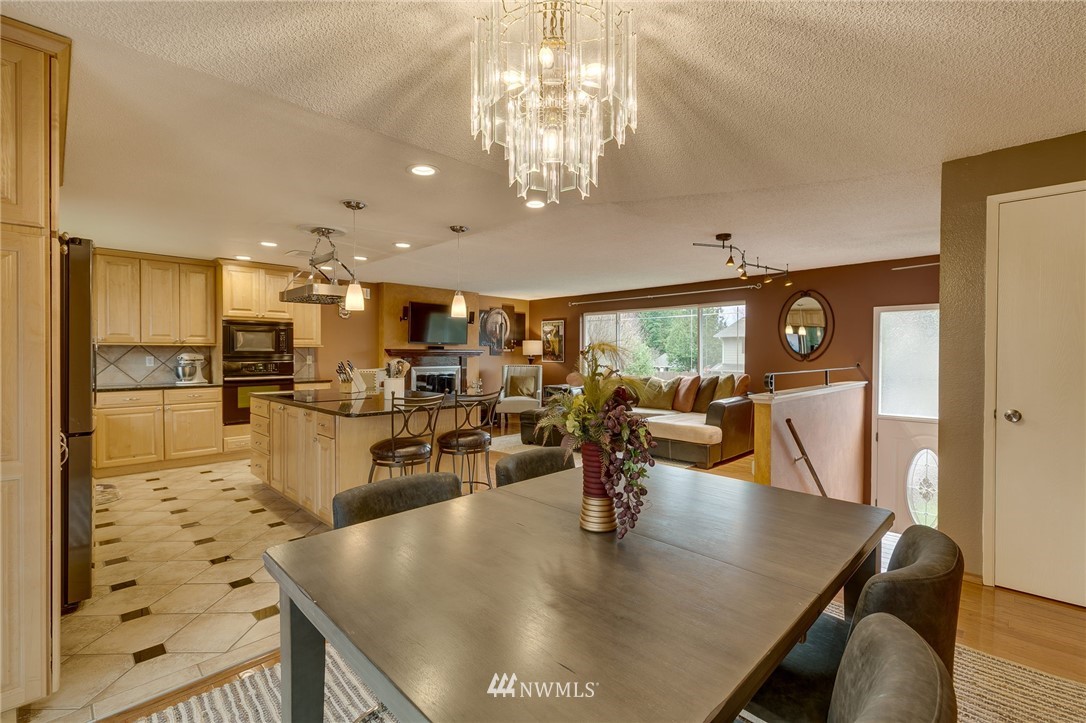 519 213th Place Southwest Bothell, WA 98021 - Photo 5 of 34 a view of a dining room and livingroom with furniture wooden floor a chandelier