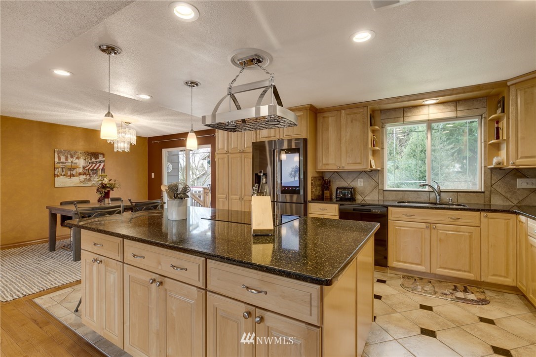 519 213th Place Southwest Bothell, WA 98021 - Photo 6 of 34 a kitchen with stainless steel appliances granite countertop a sink a stove and a refrigerator