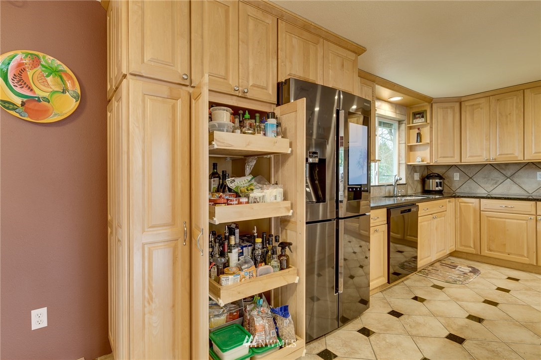 519 213th Place Southwest Bothell, WA 98021 - Photo 10 of 34 a kitchen with stainless steel appliances a refrigerator and a stove
