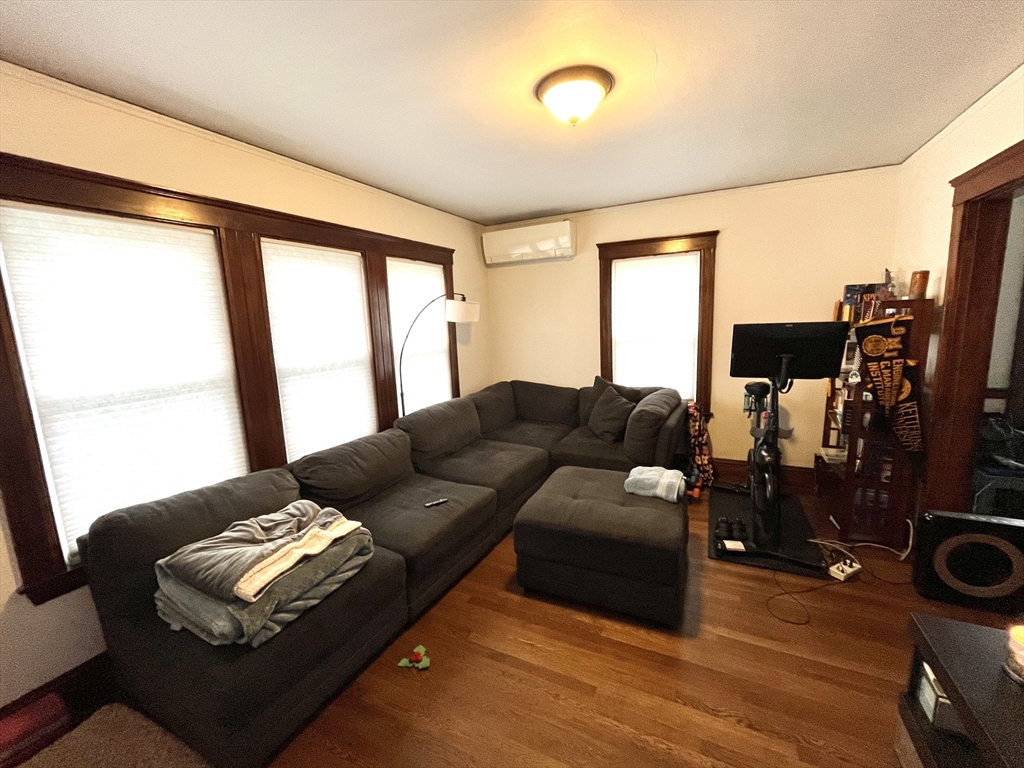 16-18 Oak Hill Road, Unit 1 Waltham, MA 02451 - Photo 1 of 11 a living room with furniture and a flat screen tv
