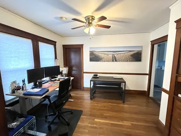 a workspace with wooden floor and a window