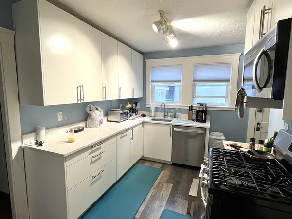 a kitchen that has a sink and a stove in it