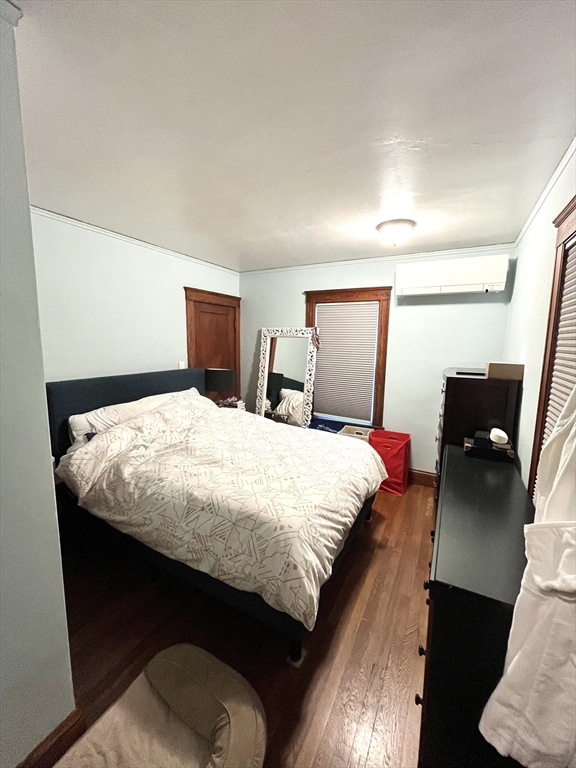 16-18 Oak Hill Road, Unit 1 Waltham, MA 02451 - Photo 8 of 11 a bedroom with a bed and wooden floor