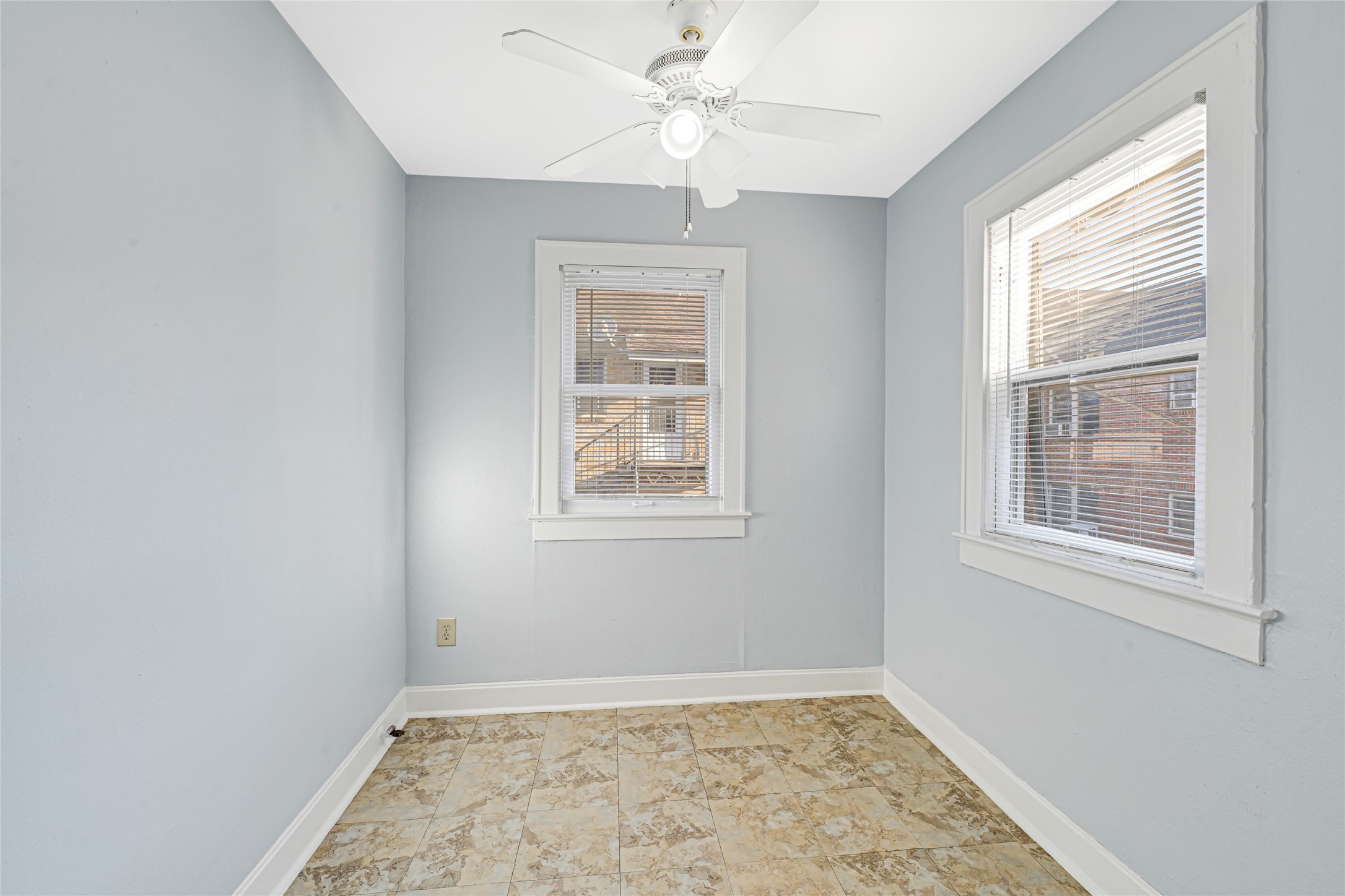 1707 Sidney Street Houston, TX 77023 - Photo 2 of 6 an empty room with a window and a fan