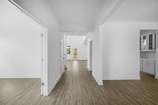 a view of a hallway with wooden floor