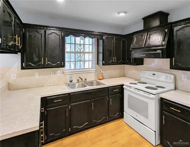 a close view of a sink and cabinets