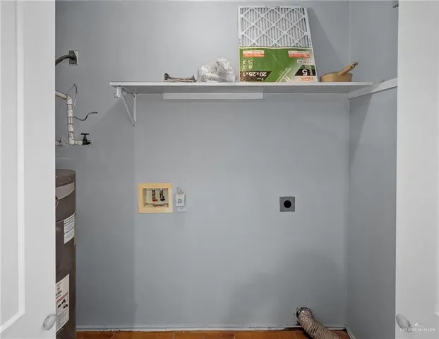 a view of an empty room with white walls and a window