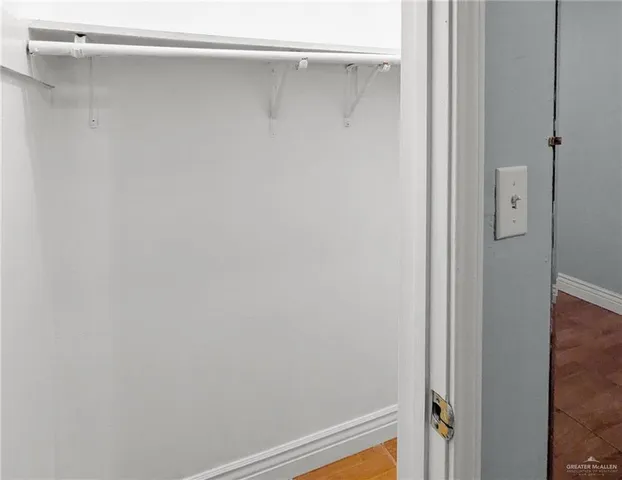 a view of a hallway with a wooden floor
