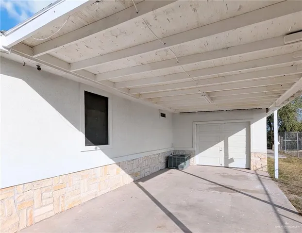 a spacious bedroom with a bed and a large window
