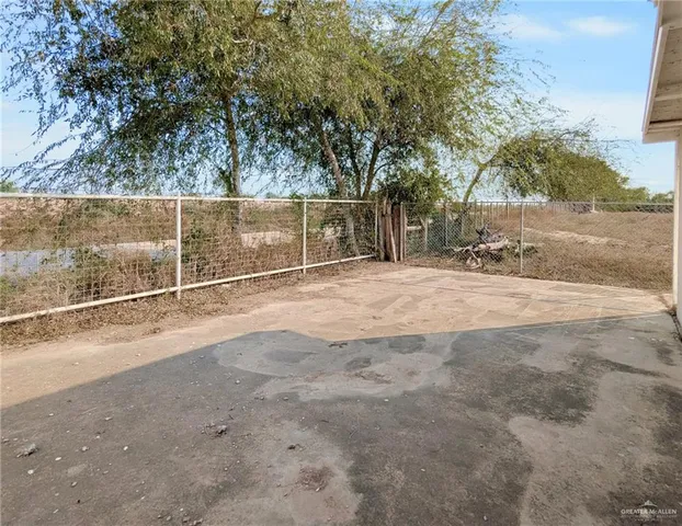 a view of a field with trees in the background