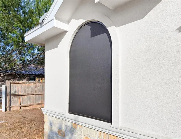 a view of a wooden door in front of a house