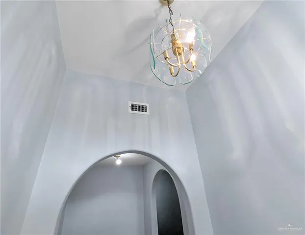 a view of a livingroom with wooden floor and a mirror