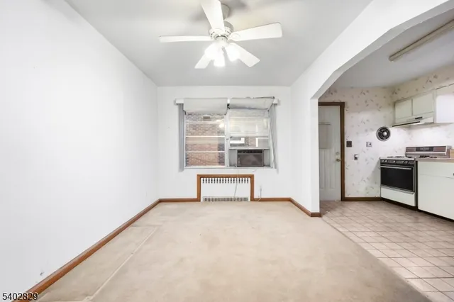 a view of a kitchen with a sink and a refrigerator