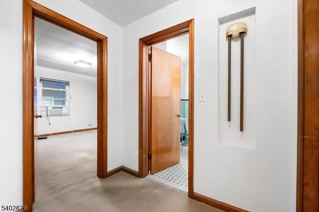 a view of a hallway with closet and wooden floor