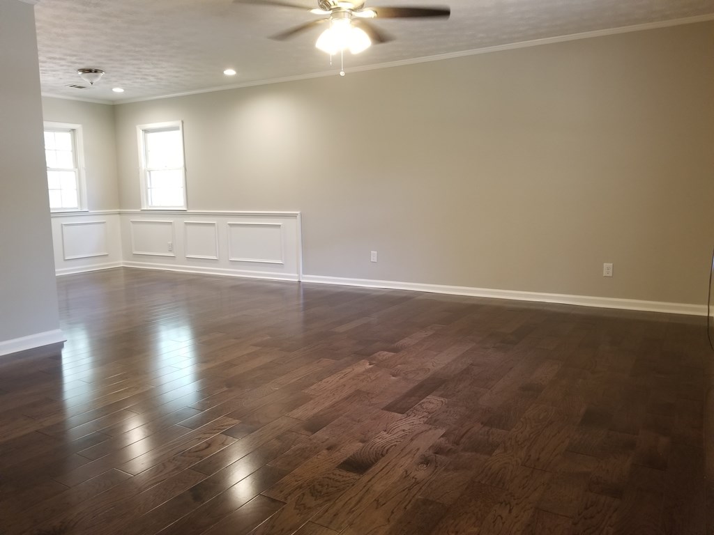 10089 County Line Road Midland, GA 31820 - Photo 11 of 27 an empty room with wooden floor and windows
