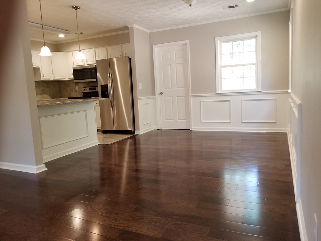 10089 County Line Road Midland, GA 31820 - Photo 12 of 27 a view of a kitchen with wooden floor and a refrigerator