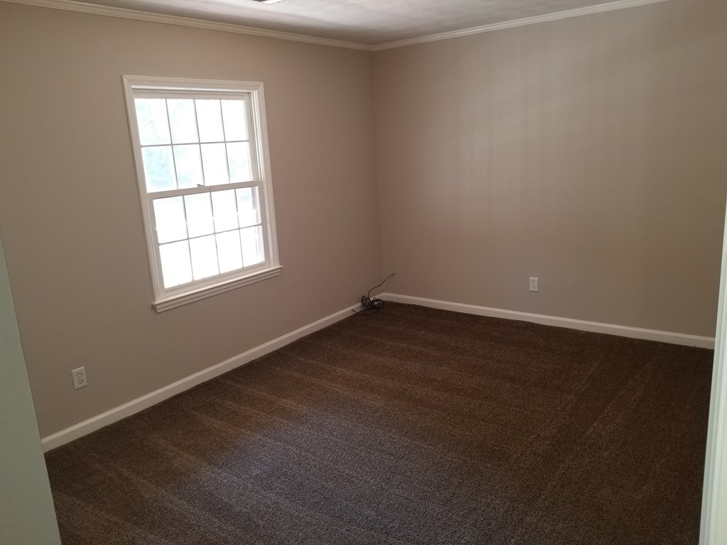 10089 County Line Road Midland, GA 31820 - Photo 19 of 27 an empty room with wooden floor and windows
