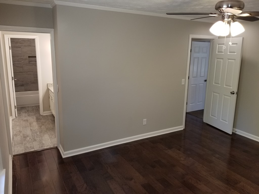 10089 County Line Road Midland, GA 31820 - Photo 22 of 27 an empty room with wooden floor and windows