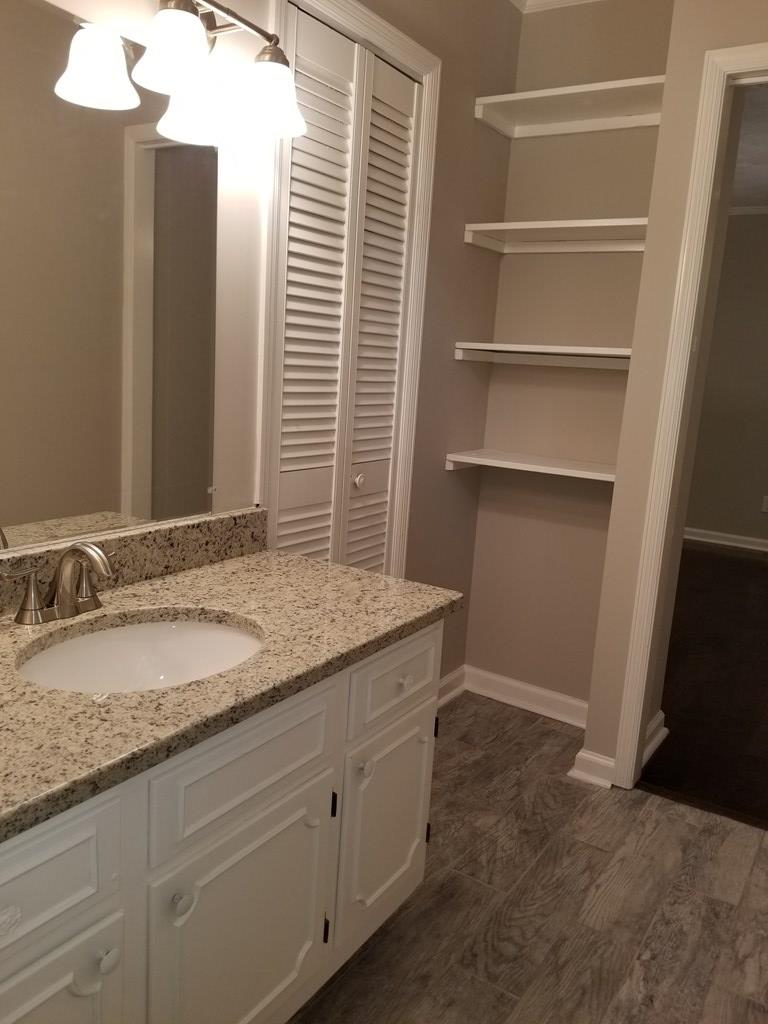 10089 County Line Road Midland, GA 31820 - Photo 25 of 27 a bathroom with a granite countertop sink and a mirror