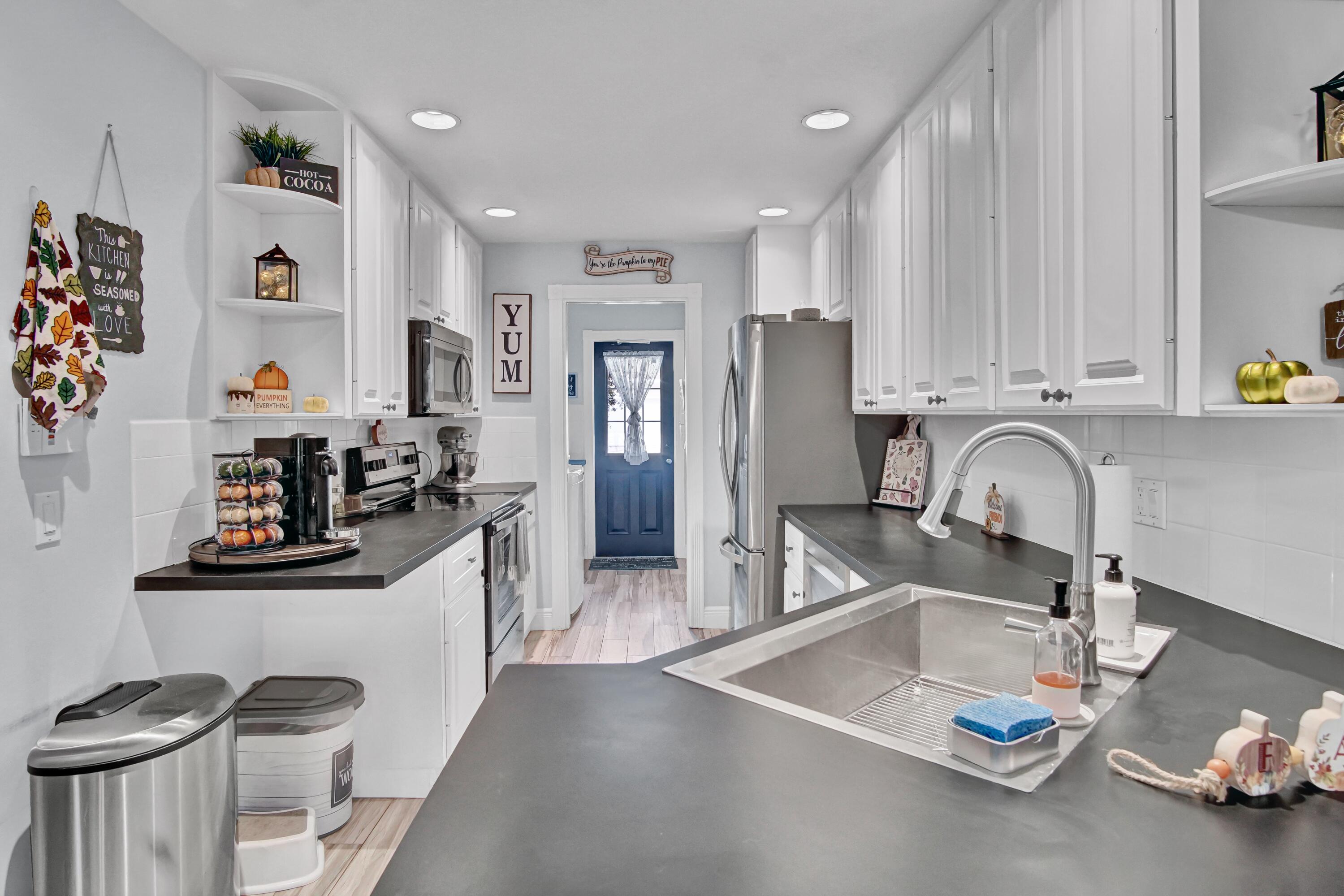 3232 West Community Drive Jupiter, FL 33458 - Photo 10 of 51 Kitchen to Laundry & Half Bath