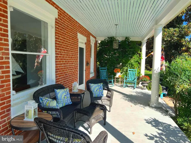 a view of a patio with couches and potted plants