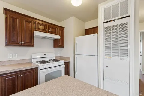 a kitchen with cabinets and white appliances