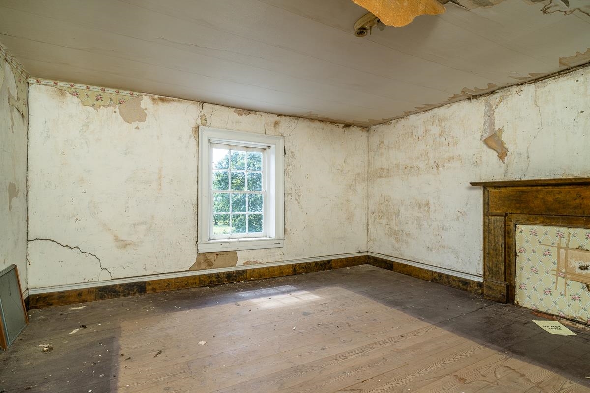 5787 Borden Grant Trail Raphine, VA 24472 - Photo 11 of 52 an empty room with a fireplace and windows