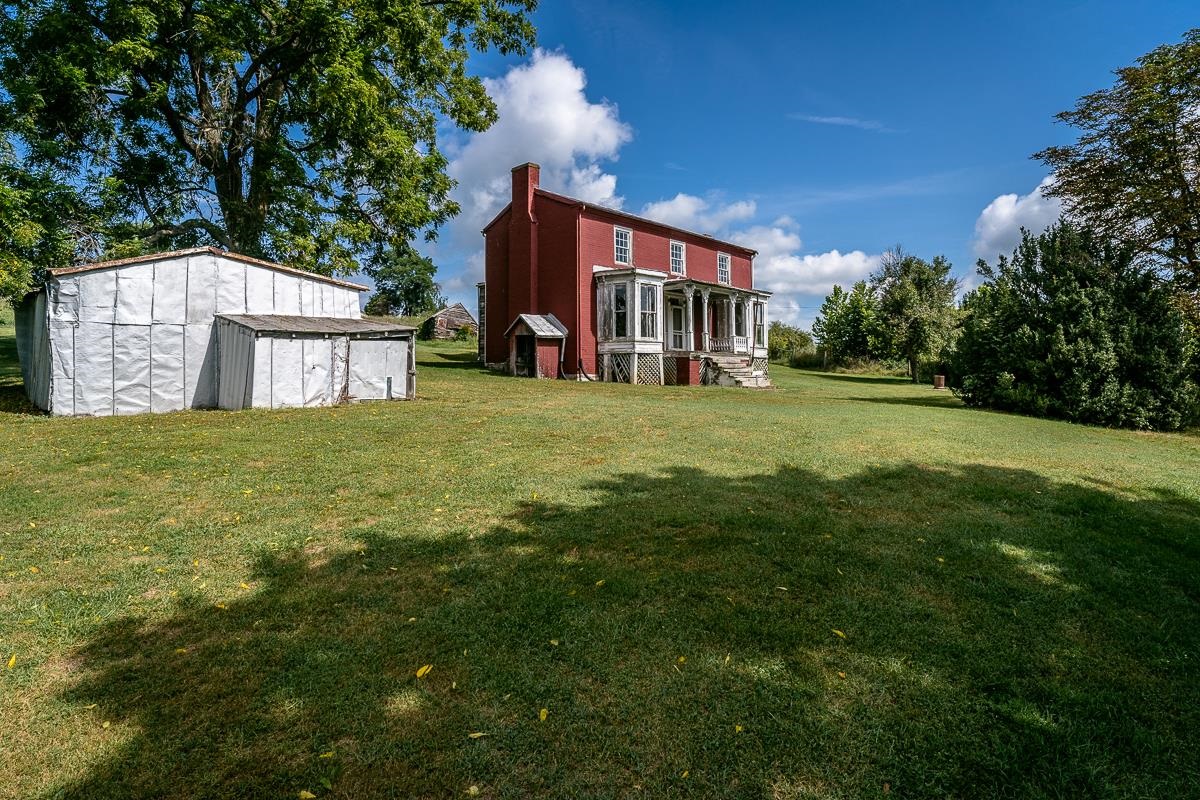 5787 Borden Grant Trail Raphine, VA 24472 - Photo 20 of 52 a view of a house with a big yard and large trees