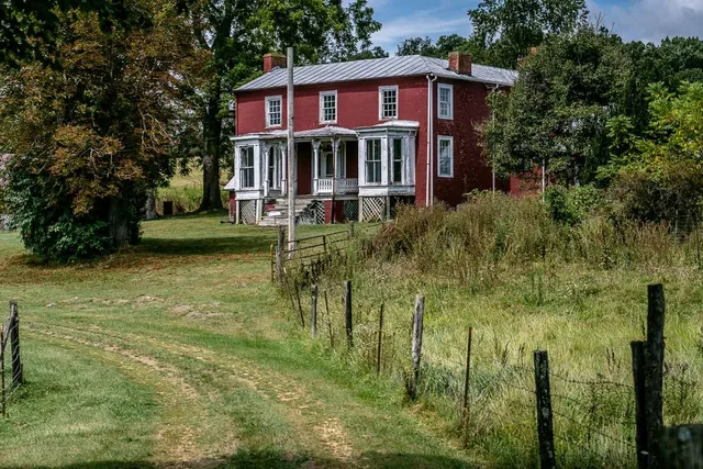a view of a house with a yard balcony and sitting area
