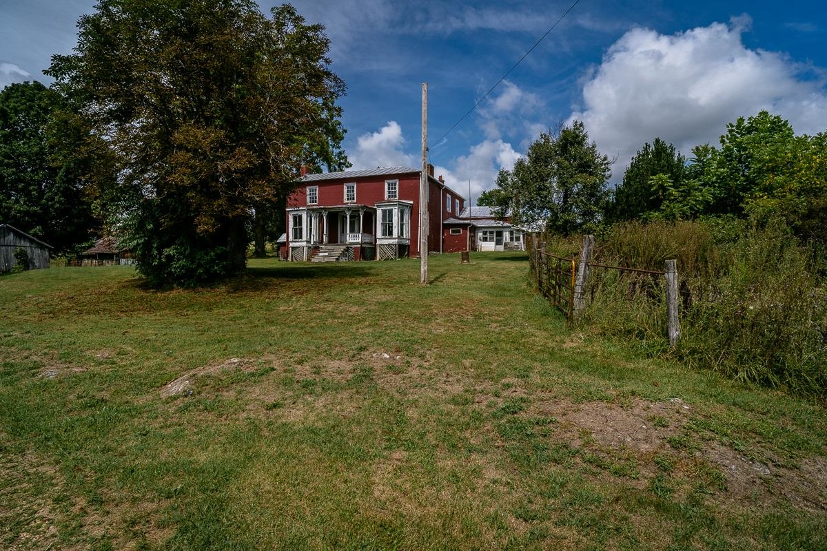5787 Borden Grant Trail Raphine, VA 24472 - Photo 28 of 52 a backyard of a house with lots of green space and lake view