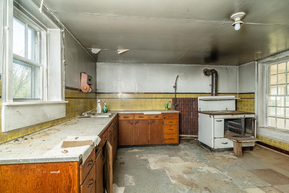 5787 Borden Grant Trail Raphine, VA 24472 - Photo 3 of 52 a kitchen with a sink a stove and chairs