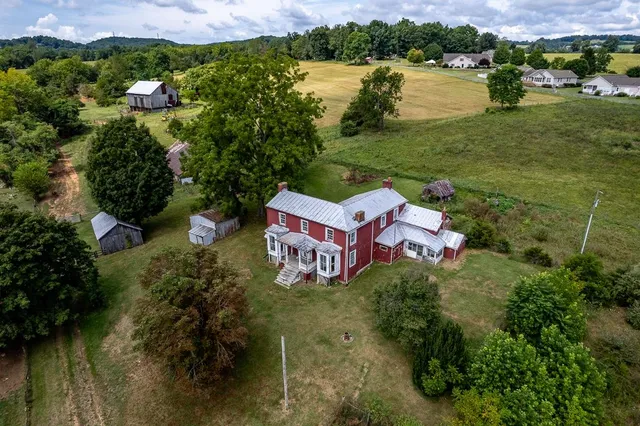 an aerial view of residential houses with outdoor space and lake view