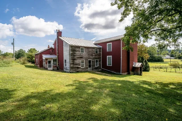 a yellow house with a yard in front of it