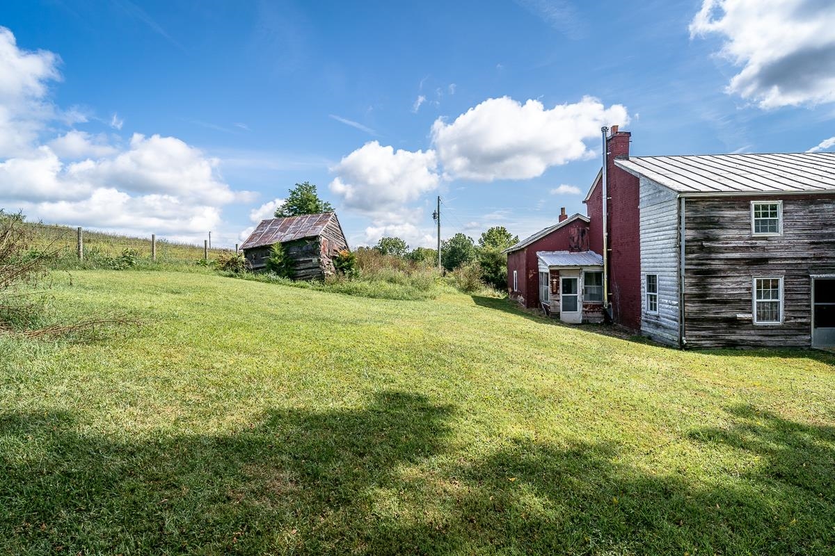 5787 Borden Grant Trail Raphine, VA 24472 - Photo 37 of 52 a yellow house with a yard in front of it