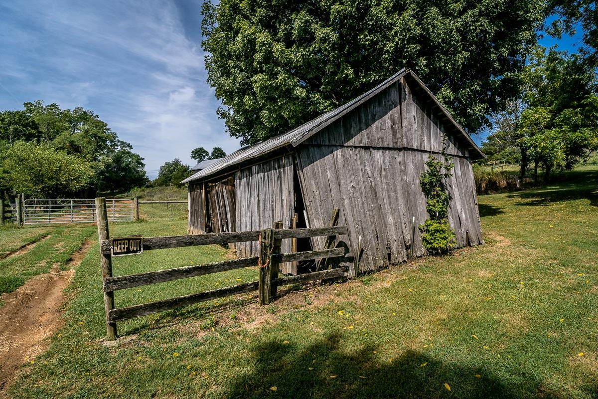 5787 Borden Grant Trail Raphine, VA 24472 - Photo 38 of 52 a view of backyard with wooden fence and a bench